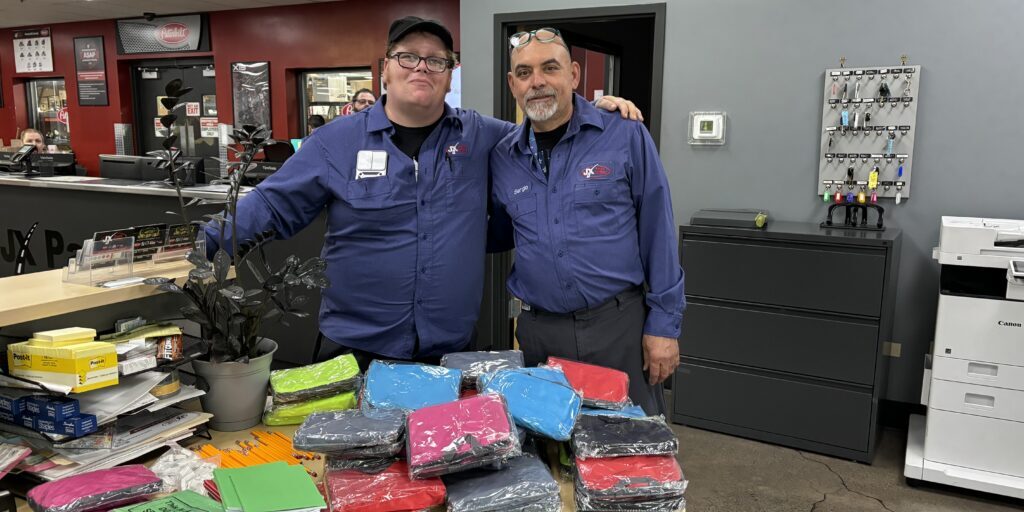 2 Elmhurst JX Employees with their school supplies donation haul