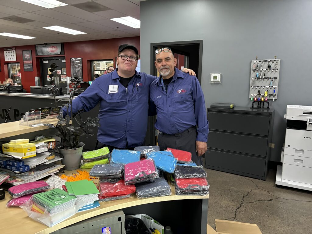2 Elmhurst JX Employees with their school supplies donation haul
